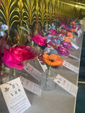Colorful floral arrangements on a table with decorative background